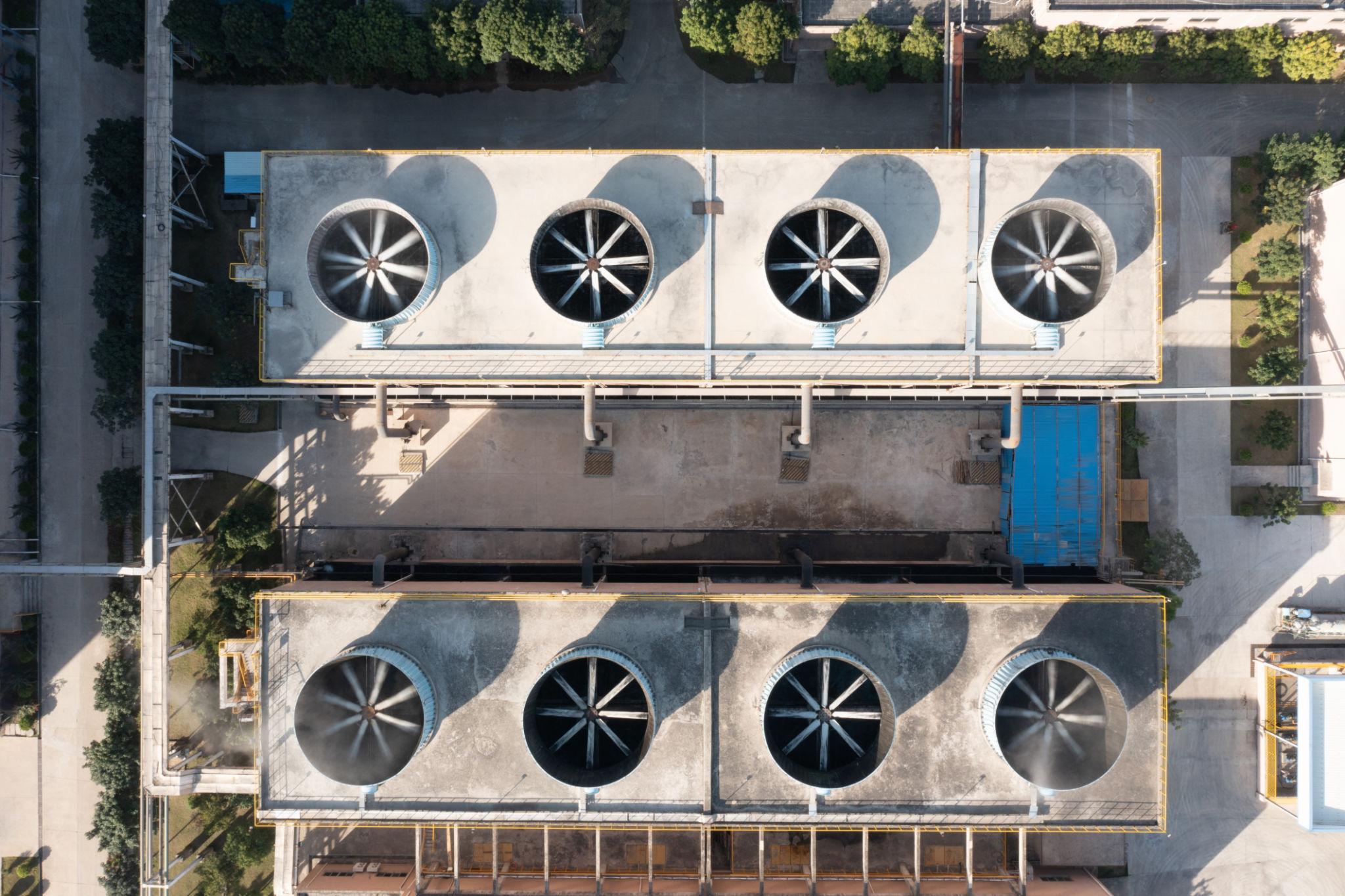 Aerial view of industrial cooling tower system with large fans